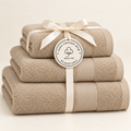 beige Sofia three towel set with ribbon and Giza Cotton Hub circular tag