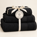 Black Sofia three towel set tied with ivory ribbon and Giza Cotton Hub circular label