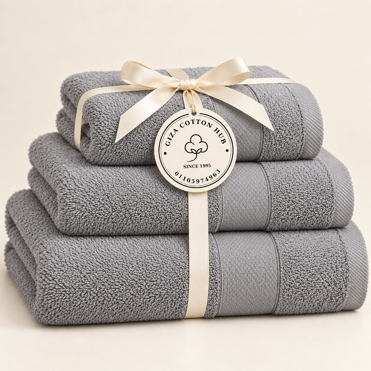 gray Sofia three towel set with ribbon and Giza Cotton Hub circular tag